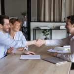 Confident,Lawyer,Meeting,And,Shaking,Hands,With,Happy,Couple,Of